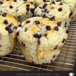 Chocolate chip muffins on a wire rack with a golden domed top.