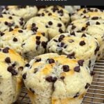Chocolate chip muffins on a wire rack with a golden domed top.