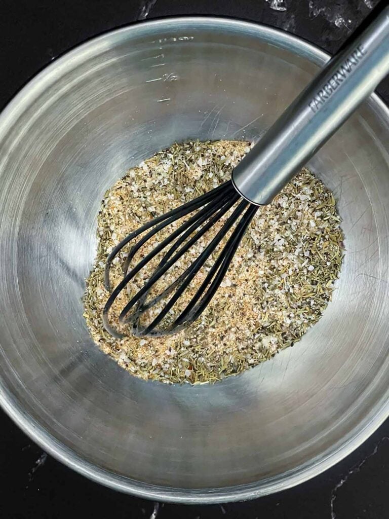 Homemade pork seasoning mixed together in a stainless steel bowl.