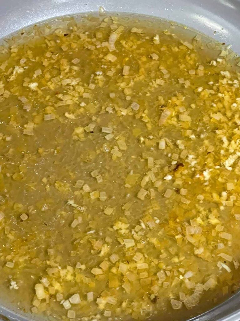 Chicken broth added to the skillet to deglaze the pan.