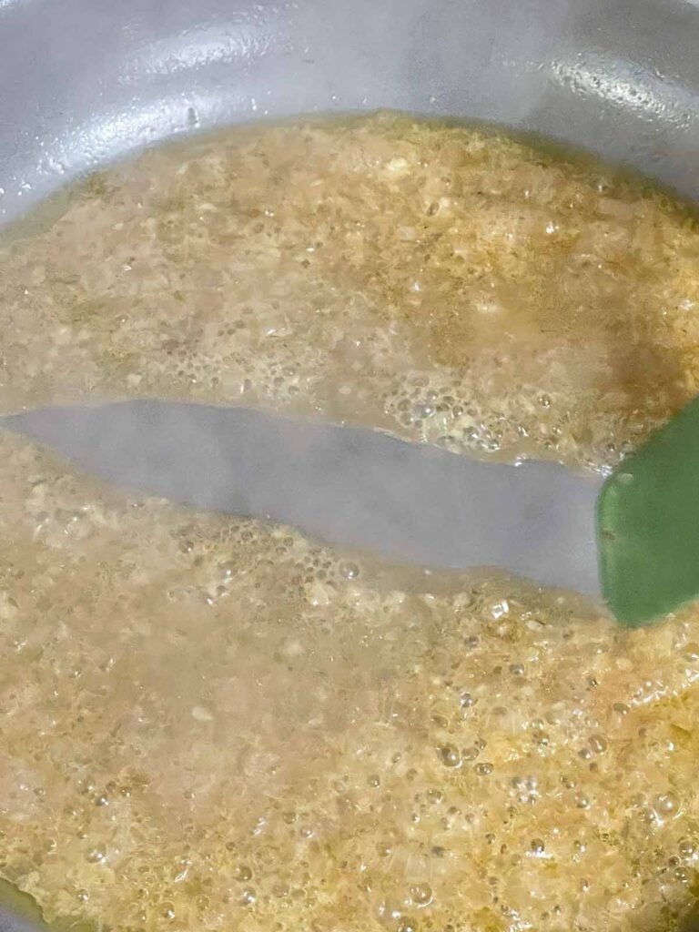 Chicken broth simmering as it reduces for the pan sauce.