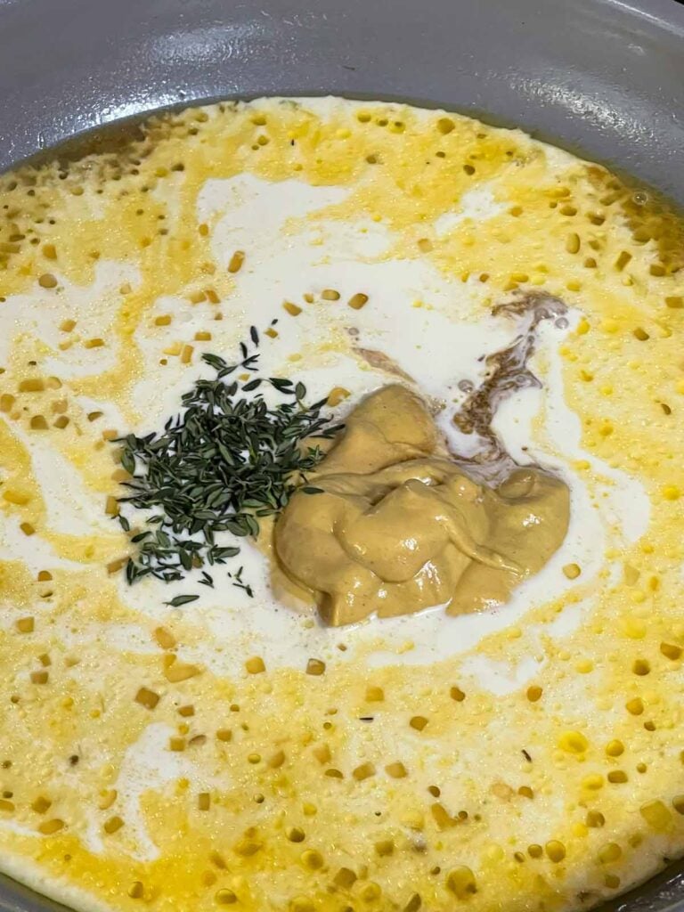 Heavy cream, Dijon mustard, Worcestershire sauce, and thyme added to the skillet.