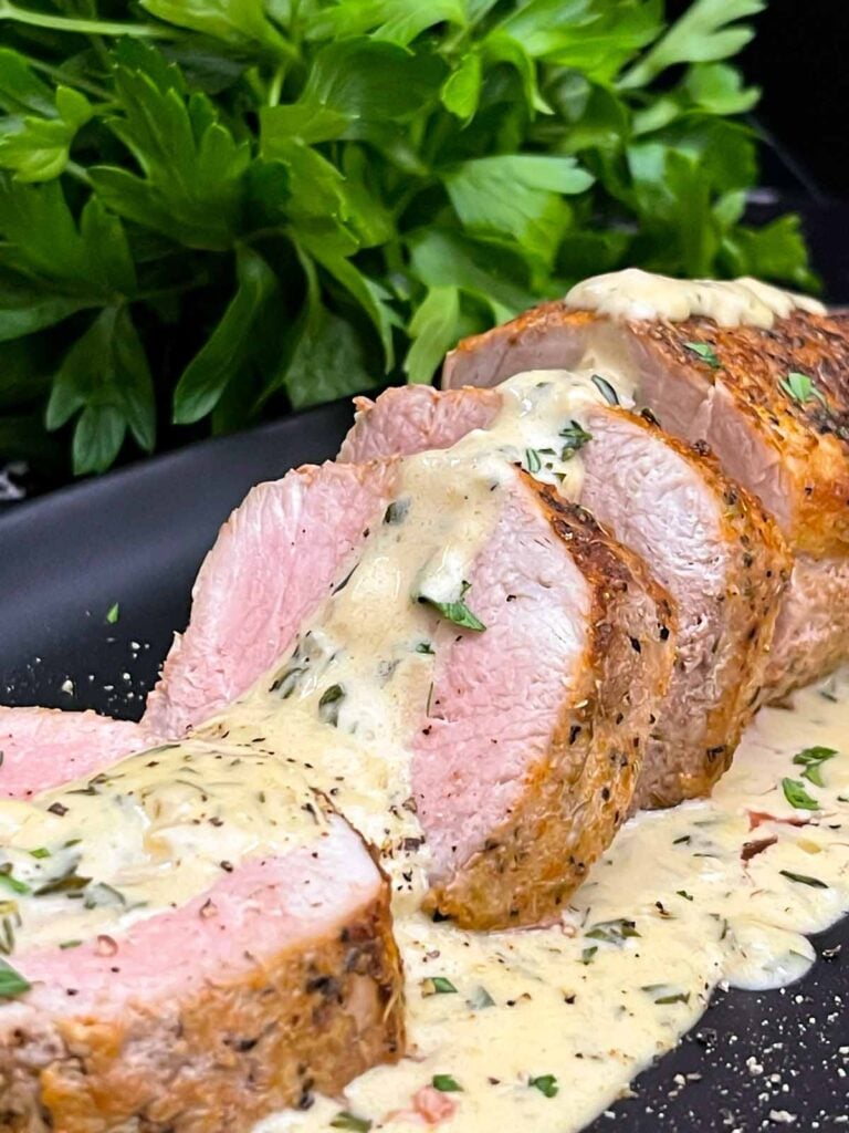 Sliced oven baked pork tenderloin topped with creamy Dijon pan sauce.