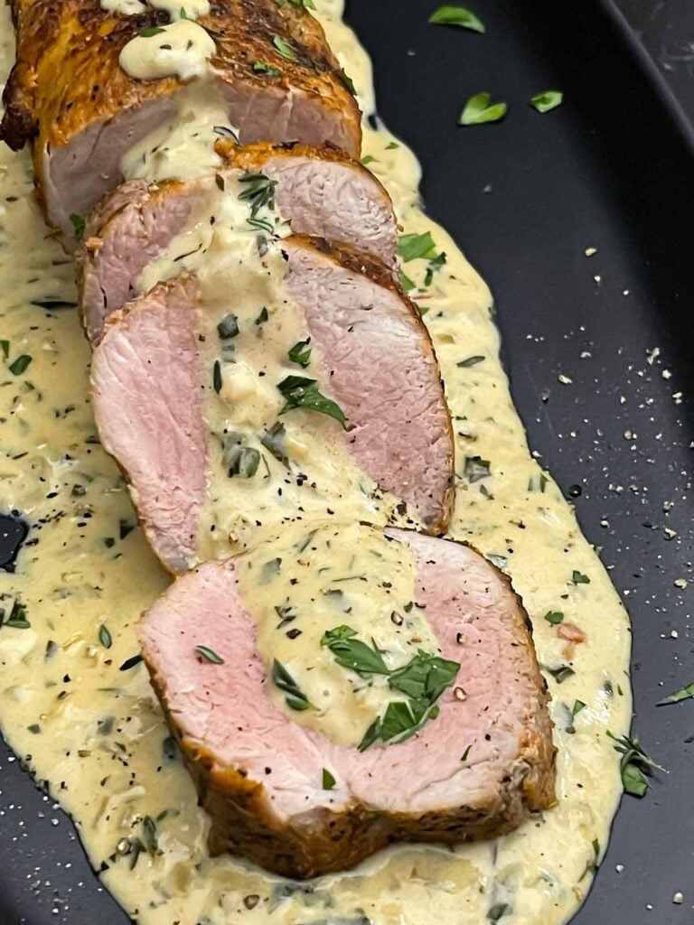 Sliced oven baked pork tenderloin topped with creamy Dijon pan sauce.