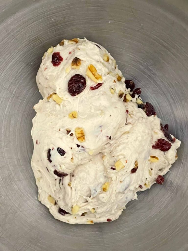 Finished cranberry walnut bread dough in the stand mixer bowl after kneading.