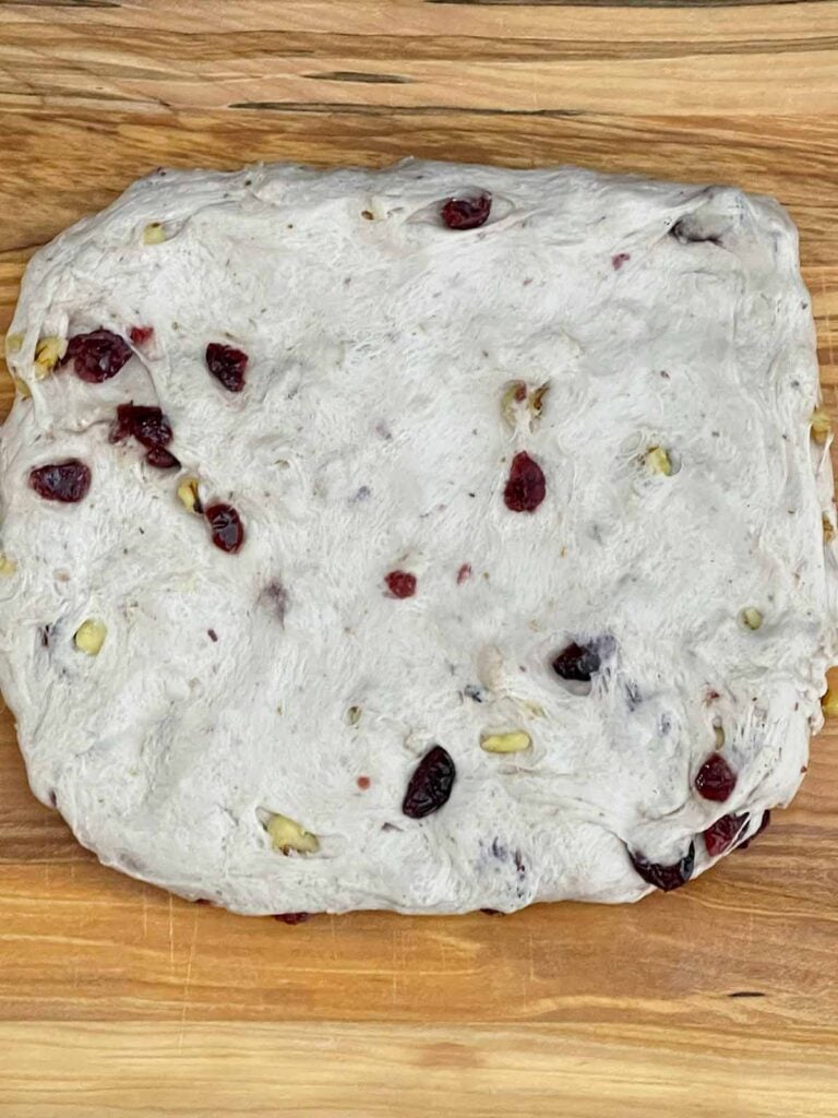 Bread dough pressed into a rough rectangle before shaping.