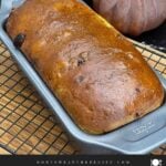 Freshly baked cranberry walnut bread in the loaf pan with a golden brown crust.