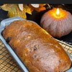 Freshly baked cranberry walnut bread in the loaf pan with a golden brown crust.