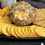 Creamy Pimento Cheese Ball with sharp cheddar and pimentos served with crackers.