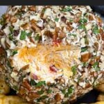 Creamy Pimento Cheese Ball with sharp cheddar and pimentos served with crackers.