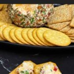 A scoop of creamy Pimento Cheese Ball on a cracker showing the cheesy pimento-filled center.