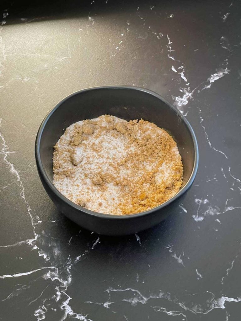 Sugars and spices for eggnog pumpkin pie mixed in a small bowl.
