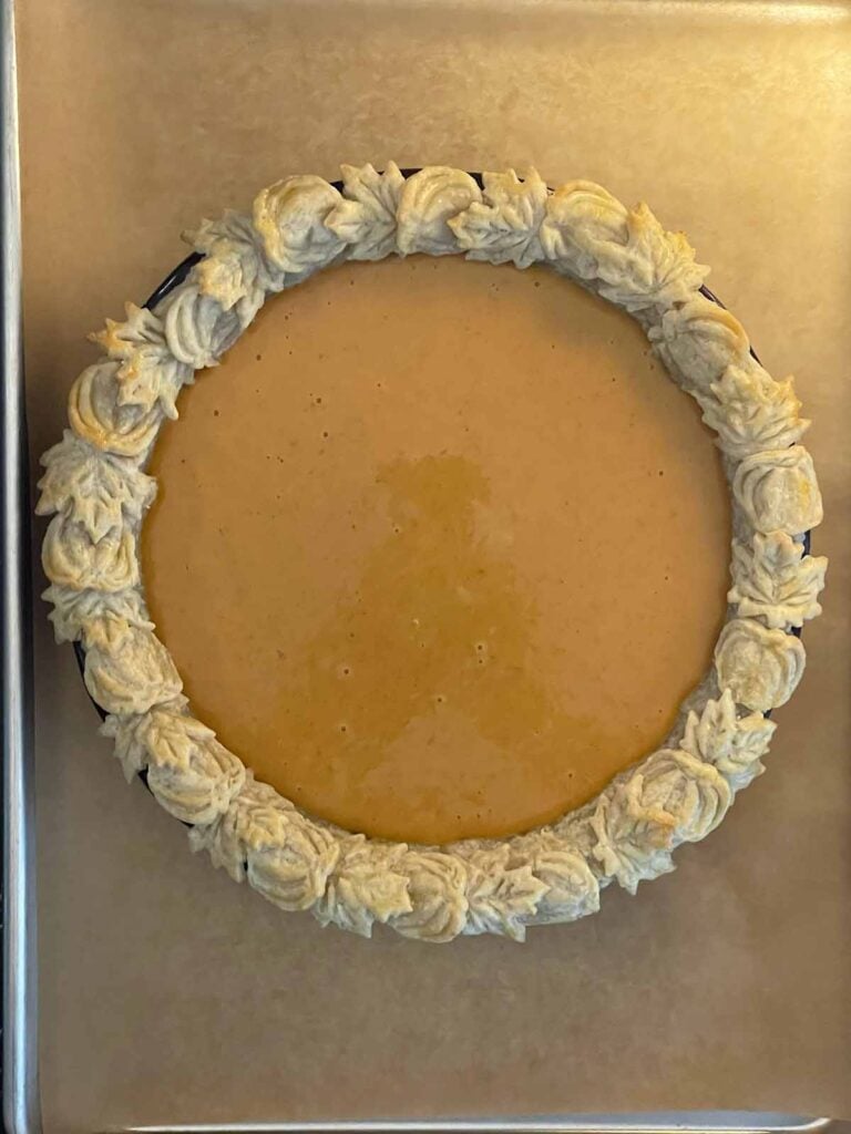 Smooth eggnog pumpkin pie filling poured into the prepared pie crust.
