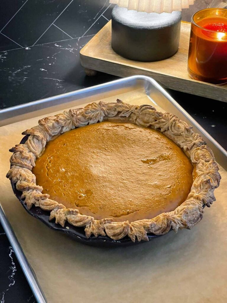 Baked eggnog pumpkin pie with a set pumpkin custard filling and golden pastry crust.