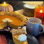 Slice of eggnog pumpkin pie topped with whipped cream.